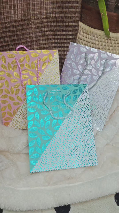 Pink goodie bag with golden embossed leaves and dots