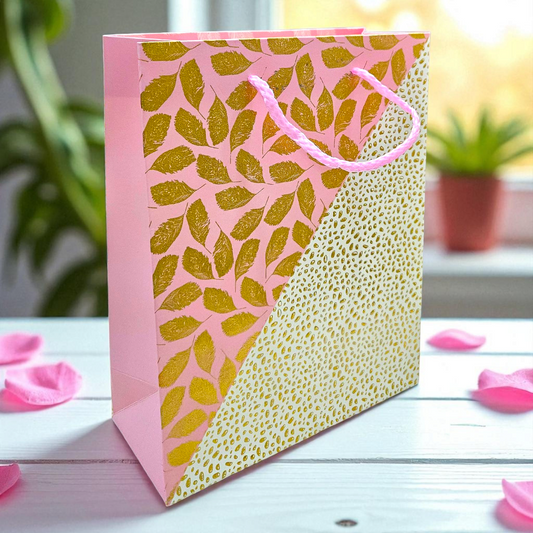 Pink goodie bag with golden embossed leaves and dots